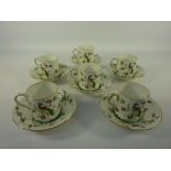 Set of six Crown Staffordshire coffee cans and saucers decorated with exotic birds and foliage