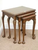 Reproduction mahogany nest of three tables on ball and claw feet,