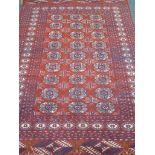 Persian Bokhara red and blue ground rug,