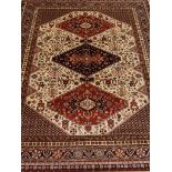 Persian Caucasion design red and beige ground rug,