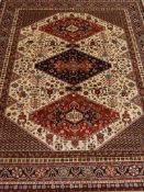 Persian Caucasion design red and beige ground rug,