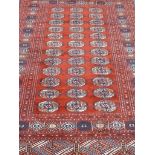 Persian Bokhara red and blue ground rug,