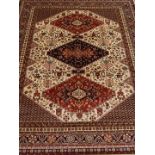 Persian Caucasian design red and beige ground rug,