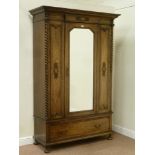 Early 20th century oak wardrobe enclosed by single mirror glazed door,
