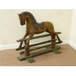 Early 20th century carved wood and painted rocking horse on trestle base,