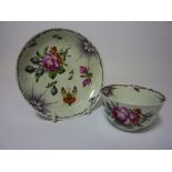 Late 18th/early 19th century tea bowl and saucer decorated with floral sprays,