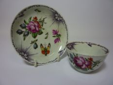 Late 18th/early 19th century tea bowl and saucer decorated with floral sprays,