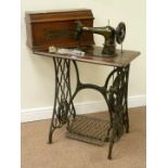 Early 20th century 'Singer' treadle sewing machine, walnut cased with cast iron base, W74cm, H101cm,