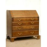 George III oak fall front bureau enclosing fitted interior above four drawers,