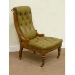 Victorian oak framed nursing chair upholstered in buttoned green leather,