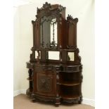 Late Victorian mahogany heavily carved display cabinet enclosed by single shaped glazed door above