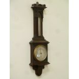 Early 20th carved oak barometer by T. Armstrong & Bro.