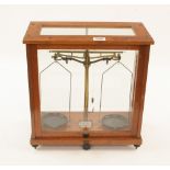 A precision balance in glass case by GEO