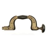 A brass framed lever pad ebony brace by