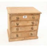 A small stripped pine four drawer chest 13"x 9"x 13" with brass knobs G+