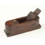 A rare 18c Italian fruitwood scrub plane 9" x 2 1/2" with a "surprised" face well carved at