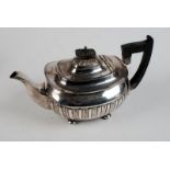 An Edwardian silver square section teapot with half fluted body raised on four bun feet, by Walker &