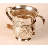 An early George III silver twin handled porringer with half fluted body, embossed floral designs