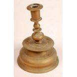 An antique Dutch brass candlestick with a circular drip tray on bell shaped base. Height 20cm,