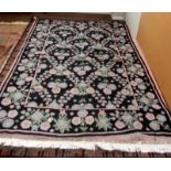 A Kashmir black ground, crewel work rug,