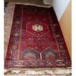 A Hamadan rug with red ground and centra