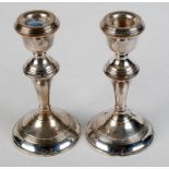 A pair of filled silver candlesticks, by