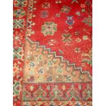 An Eastern, red ground, hand knotted rug