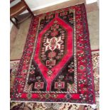 An eastern hand-knotted rug with central