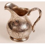 A Chinese silver coloured milk jug of baluster form with bamboo modelled handle and bamboo engraving