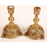 A pair of unusual brass candlesticks in Tudor style, the domed bases cast with stylized cats and