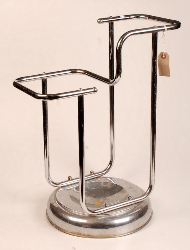 A 1930's tubular chrome stick stand on a