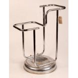 A 1930's tubular chrome stick stand on a