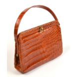 A vintage brown snake skin hand bag with fawn, kid leather interior.