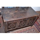 A late 17th century carved and panelled joined oak coffer.  Width 111cm.