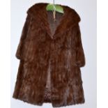 A 'Rackham's' mid length brown fur coat.