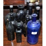 A collection of mostly old green glass beer bottles and a blue glass American S.S. Stafford's Inks