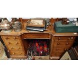 A mahogany desk with a concave drawer, flanked by two pedestals, each with four drawers.