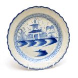 An 18th century blue and white chinoiserie, feather edge, earthenware plate, diameter 24.