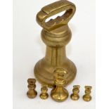 A set of six butcher's shop brass bell weights.