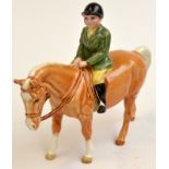 A Beswick boy on a pony.