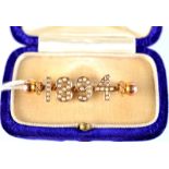 An 1894 high purity, pearl set gold brooch.
