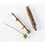 An ornate silver propelling pencil, a gold propelling pencil and a gold stickpin.