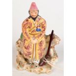 A Victorian Staffordshire pottery model of a Russian hunter, he stands with fur coat,