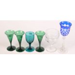 A cut glass rummer by Webb, four Victorian green glasses and a cut blue overlay glass.