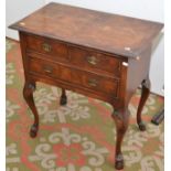 A reproduction Queen Anne mahogany low boy with two short drawers above a longer drawer on cabriole