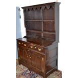 An oak dresser in early 18th century style the back with two open shelves,