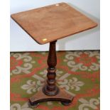 A small mahogany pedestal table on a trefoil base.