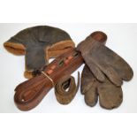 A leather flying helmet, a pair of leather pilot mittens and a canvas belt,