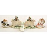 A pair of continental porcelain small groups, each with a cherub,