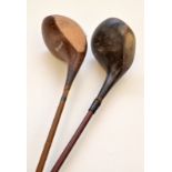 A pair of Canadian golf drivers with composition shafts and wooden heads.